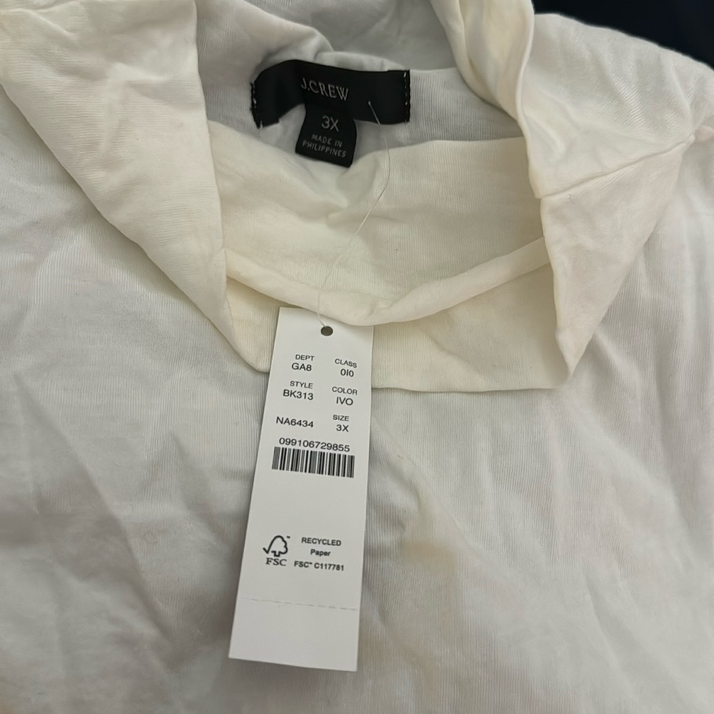 Woman’s cream turtleneck tank.